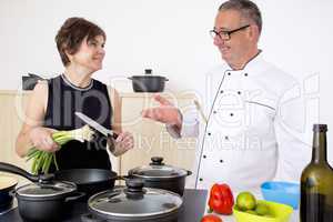 Elegant woman with Chef Cook in the kitchen