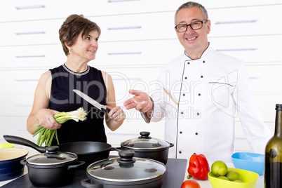 Elegant woman with Chef Cook in the kitchen