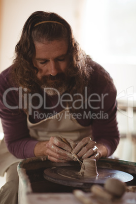 Male potter working on bowl