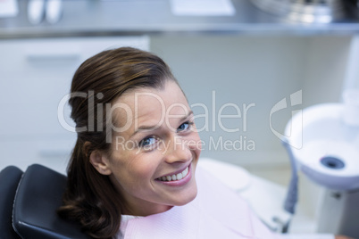 Female patient sitting on dentist chair