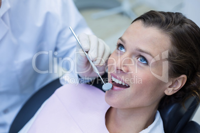 Patient teeth being examined with angle mirror