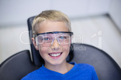 Smiling young patient sitting on dentist chair