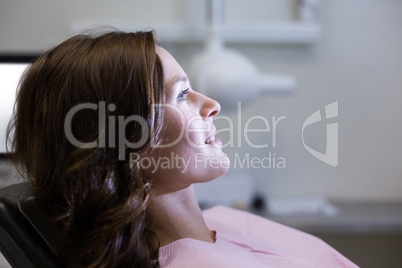 Female patient sitting on dentist chair