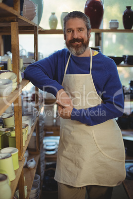 Male potter standing in pottery workshop