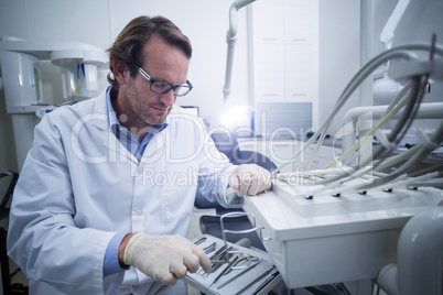 Dentist looking at dental tool