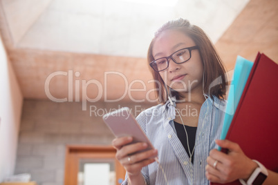 Young woman using mobile phone in corridor Young woman using mobile phone in corridor