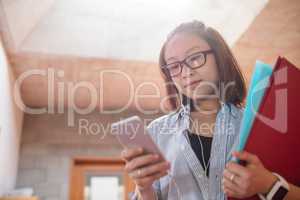 Young woman using mobile phone in corridor