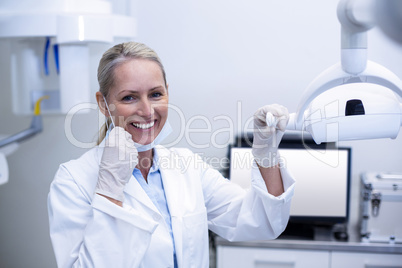 Female dentist holding dental lights