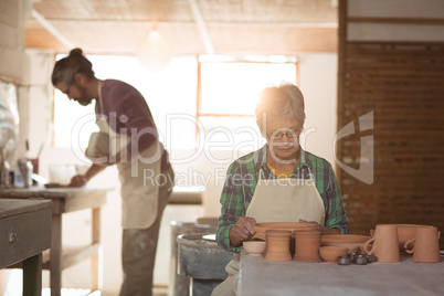 Female potter examining a earthenware pot