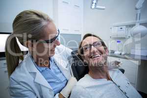 Female dentist interacting with male patient