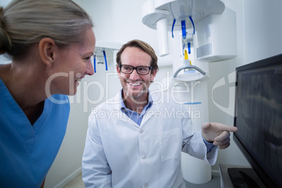 Dentist and dental assistant discussing a x-ray on the monitor