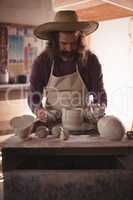 Male potter making pot
