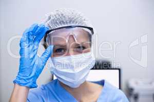 Dental assistant with surgical mask and safety glasses