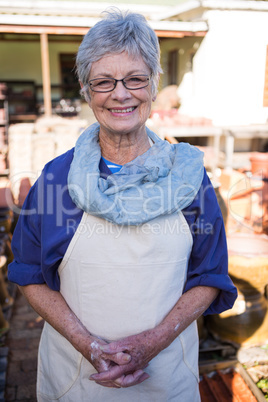 Female potter standing in pottery workshop