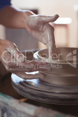 Close-up of female potter making pot