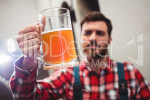 Manufacturer holding beer in jug