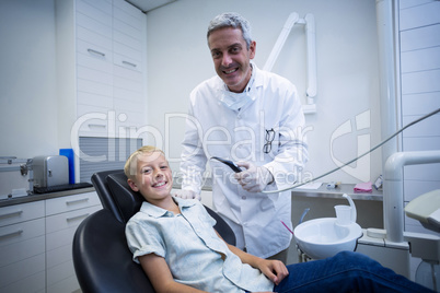 Dentist examining a young patient with tools