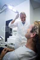 Female dentist interacting with male patient