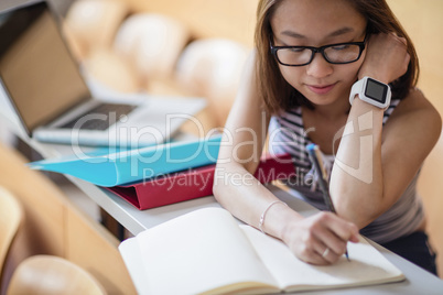 Young woman studying in classroom