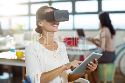 Female graphic designer in virtual reality headset using digital