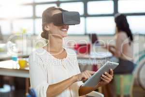Female graphic designer in virtual reality headset using digital
