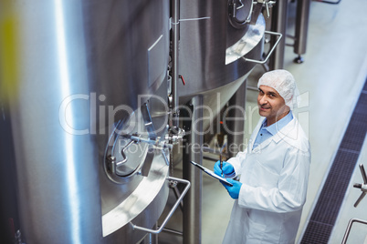 portrait of manufacturer standing at brewery