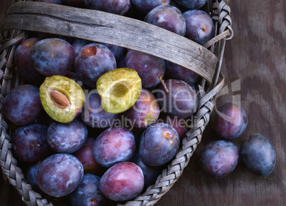 Fresh ripe black plums in a basket