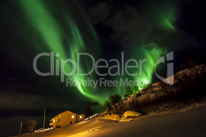 Strong bright green aurora northern lights over mountain