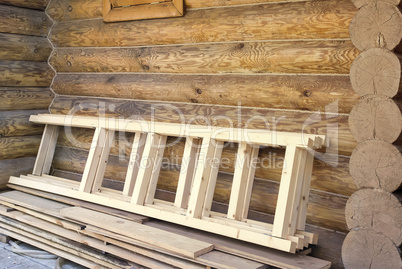 Wooden stairs and timber house wall.