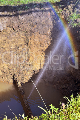 The water jet in the form of leakage in the damaged metal pipe a