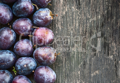 ripe plum on a wooden background