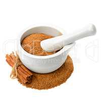 powder and cinnamon sticks, mortar with pestle isolated on white