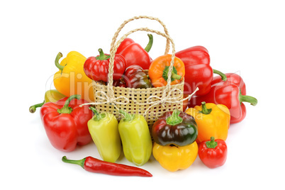 Set bell peppers in a basket isolated on a white background