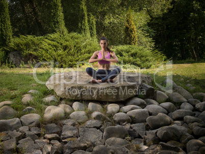 Girl meditates in the lotus position.