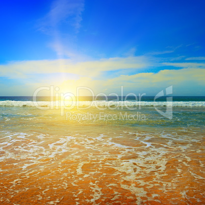 ocean, sandy beach, blue sky and sunrise