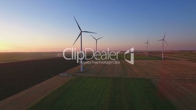 Aerial view of cluster of wind turbines in rural agriculture field.