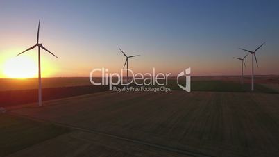 Aerial view of cluster of wind turbines in rural agriculture field.