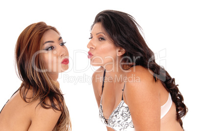 Two women blowing kisses.