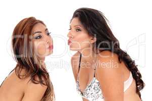 Two women blowing kisses.