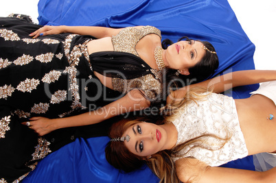Two women lying on floor.