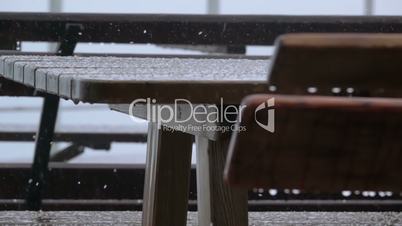 Outdoor Table and Bench. Rain and Hail. Slow Motion