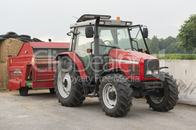 Red tractor with red cattle feed diffuser.
