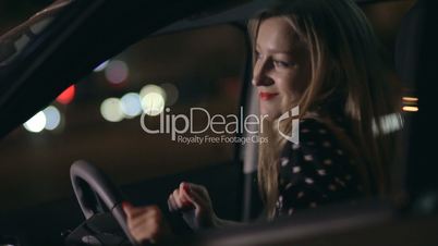 Woman in car having fun at night dancing