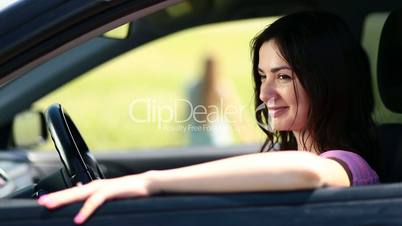 Side view of attractive woman driver in car window