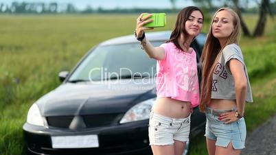 Two cute women making selfies on roadtrip