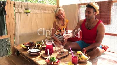 Young couple chatting during lunch on tree house