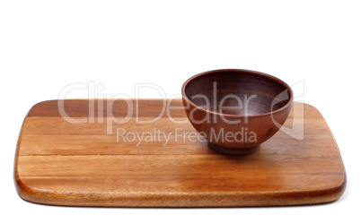 Empty ceramic bowl on wooden kitchen board