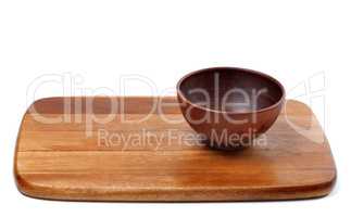Empty ceramic bowl on wooden kitchen board