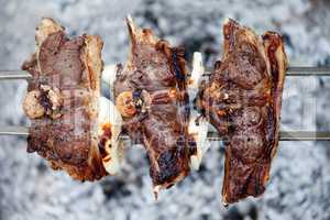 Shashlik of lamb cooking on bonfire