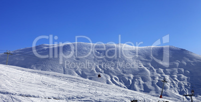 Panoramic view on gondola lift and ski slope